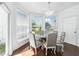 Dining room with windows, a round table, and soft-upholstered chairs at 205 Norfolk Pl, Celebration, FL 34747