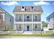 Charming two-story home with a double balcony and a manicured front yard at 205 Norfolk Pl, Celebration, FL 34747