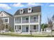 Inviting two-story home featuring double porches and a well-maintained lawn, exuding classic charm at 205 Norfolk Pl, Celebration, FL 34747