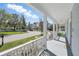 Relaxing front porch overlooking the street with lovely homes and landscaped yards in the neighborhood at 205 Norfolk Pl, Celebration, FL 34747