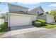 Attached two-car garage featuring an attractive exterior and manicured landscaping at 205 Norfolk Pl, Celebration, FL 34747