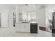 Open kitchen with white cabinets, marble countertops, and a seamless connection to the living area at 205 Norfolk Pl, Celebration, FL 34747