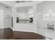 Modern, open-concept kitchen with white cabinets, marble countertops, and stainless steel appliances at 205 Norfolk Pl, Celebration, FL 34747