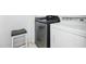 Bright laundry room with modern, front load washer and white dryer, plus stool at 205 Norfolk Pl, Celebration, FL 34747