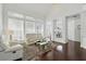Bright and airy living room with hardwood floors, large windows, and modern decor at 205 Norfolk Pl, Celebration, FL 34747