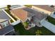 An aerial view displays a well maintained lawn, with a stone garden, and mature landscaping at 2224 Paria Ln, Kissimmee, FL 34758