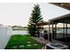 This backyard has a built-in outdoor kitchen with a grill, and is lined by a white fence with a lake view at 2224 Paria Ln, Kissimmee, FL 34758
