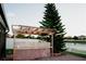This backyard has an outdoor kitchen and a white fence that surrounds the yard for privacy, plus a view of a lake at 2224 Paria Ln, Kissimmee, FL 34758