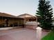 This backyard has an outdoor kitchen, a patio, and is lined by a white fence with a view of the neighboring house at 2224 Paria Ln, Kissimmee, FL 34758