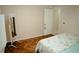 Bright bedroom with herringbone wood floors and white walls at 2224 Paria Ln, Kissimmee, FL 34758