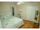 Bright bedroom with decorative bedding, mirrored dresser and herringbone wood flooring at 2224 Paria Ln, Kissimmee, FL 34758