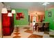 Bright dining area with green accent wall, tile flooring, and an open layout that connects to the living spaces at 2224 Paria Ln, Kissimmee, FL 34758