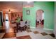 An open dining space featuring tiled floors, green walls, and connection to the living room at 2224 Paria Ln, Kissimmee, FL 34758