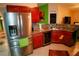 The kitchen featuring stainless steel refrigerator and wine cooler built into wooden cabinetry at 2224 Paria Ln, Kissimmee, FL 34758