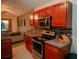 The kitchen boasts stainless steel appliances, a decorative backsplash, and wooden cabinets at 2224 Paria Ln, Kissimmee, FL 34758