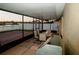 Enclosed patio with outdoor dining area and grill overlooking a tranquil lake at 2224 Paria Ln, Kissimmee, FL 34758