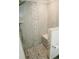 Stylish shower with stone pebble details, a built-in bench, and modern fixtures at 2224 Paria Ln, Kissimmee, FL 34758