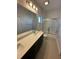 Bathroom showcasing a double sink vanity, a glass shower, and a window at 231 Villa Domani Cir # 59, Davenport, FL 33896