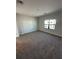 Well-lit bedroom with a large window, closet, and neutral carpet flooring at 231 Villa Domani Cir # 59, Davenport, FL 33896