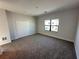 Neutral bedroom with carpet, closet, and window overlooking the neighborhood at 231 Villa Domani Cir # 59, Davenport, FL 33896