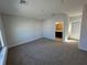 Carpeted bedroom featuring a window, a closet, and a doorway to the bathroom at 231 Villa Domani Cir # 59, Davenport, FL 33896