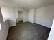 Upstairs bonus room with neutral carpet, white walls, and ample lighting at 231 Villa Domani Cir # 59, Davenport, FL 33896