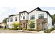 Beautifully designed townhouses with stone accents, modern windows, and well-maintained landscaping at 231 Villa Domani Cir # 59, Davenport, FL 33896