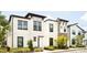 Elegant townhouses featuring contemporary architecture, manicured lawns, and inviting curb appeal at 231 Villa Domani Cir # 59, Davenport, FL 33896
