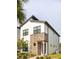 Stylish townhouse showcasing a combination of stucco and stone facade, complemented by verdant landscaping at 231 Villa Domani Cir # 59, Davenport, FL 33896