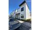 Stylish townhouse with a clean white facade, dark accents, and meticulous landscaping at 231 Villa Domani Cir # 59, Davenport, FL 33896