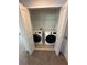 Bright laundry closet featuring a modern, stacked washer and dryer unit at 231 Villa Domani Cir # 59, Davenport, FL 33896