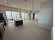 Open-concept living space featuring a kitchen island, tile flooring, and abundant natural light at 231 Villa Domani Cir # 59, Davenport, FL 33896