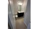 Modern powder room with a dark vanity, framed mirror, and neutral finishes at 231 Villa Domani Cir # 59, Davenport, FL 33896