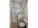 Bright, modern bathroom with glass-enclosed shower and toilet at 231 Villa Domani Cir # 59, Davenport, FL 33896