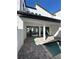 Modern backyard with a splash pool, brick patio, and a covered outdoor space at 231 Villa Domani Cir # 59, Davenport, FL 33896