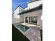 Inviting splash pool with brick patio and artificial turf in a modern backyard at 231 Villa Domani Cir # 59, Davenport, FL 33896