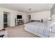 This main bedroom features neutral walls, carpet, and a flat screen TV at 2755 Monticello Way, Kissimmee, FL 34741