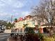 Attractive exterior of the hotel on a sunny day with lovely landscaping and mature trees at 3000 Maingate Ln # 330, Kissimmee, FL 34747