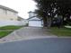 Charming two-story home featuring mature trees and a well-maintained front lawn at 3007 Bransbury Ct, Kissimmee, FL 34747