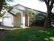 Charming exterior featuring a well-maintained lawn, arched entryway, and two-car garage at 3007 Bransbury Ct, Kissimmee, FL 34747