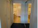 Hallway view leading to a tiled bathroom with white cabinets and a matching white shutter-style closet at 3007 Bransbury Ct, Kissimmee, FL 34747