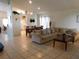 Open-concept living room with tile flooring, high ceilings, and an adjacent dining area at 3007 Bransbury Ct, Kissimmee, FL 34747
