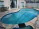 Relax by the gorgeous in-ground pool surrounded by a screened enclosure and an outdoor patio at 3007 Bransbury Ct, Kissimmee, FL 34747