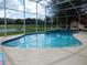 Enjoy the refreshing in-ground screened pool with its relaxing view of the nearby pond at 3007 Bransbury Ct, Kissimmee, FL 34747