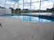 Refreshing pool area with a screened-in enclosure, offering picturesque lake views, perfect for unwinding at 3007 Bransbury Ct, Kissimmee, FL 34747
