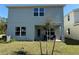 View of the backyard showing the house, patio and small yard at 3600 Sagefield Dr, Harmony, FL 34773