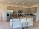 Well-equipped kitchen featuring granite countertops, stainless steel appliances, and a central island with bar seating at 3600 Sagefield Dr, Harmony, FL 34773