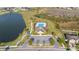 Aerial shot showcases a community pool, clubhouse, and scenic pond at 3675 Cabo Ln, St Cloud, FL 34772