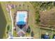 Aerial view of a community pool and clubhouse next to a small pond at 3675 Cabo Ln, St Cloud, FL 34772