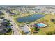 Aerial view of a neighborhood featuring houses surrounding a tranquil lake at 3675 Cabo Ln, St Cloud, FL 34772